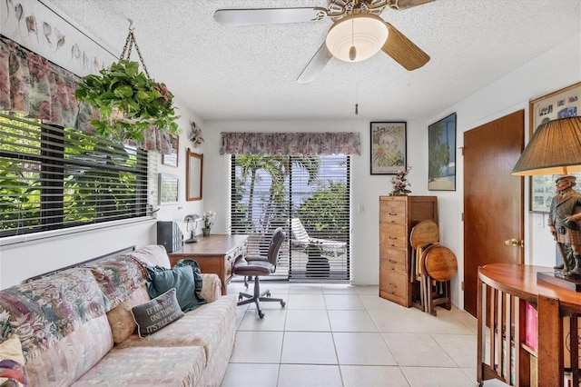 tiled office space with ceiling fan, a textured ceiling, and a healthy amount of sunlight