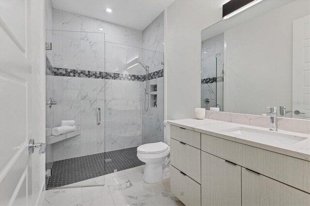 bathroom featuring a shower with shower door, toilet, and vanity