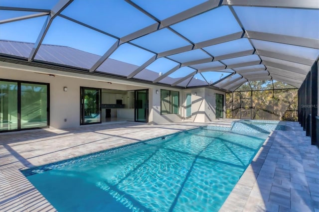 view of swimming pool with a patio area and glass enclosure