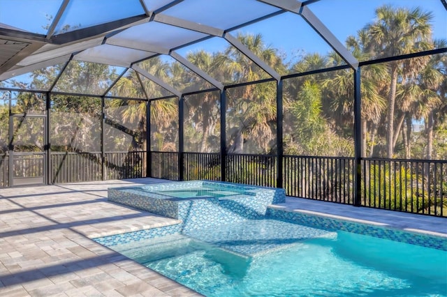 view of swimming pool featuring a lanai, an in ground hot tub, and a patio