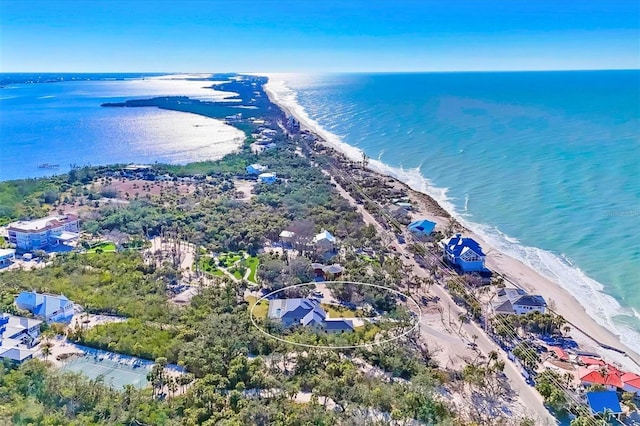 drone / aerial view featuring a water view and a beach view