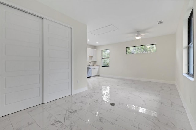 interior space featuring attic access, marble finish floor, visible vents, and baseboards