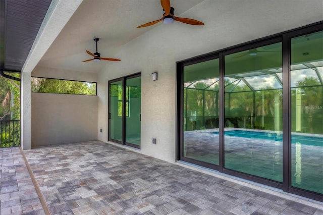 view of patio / terrace featuring ceiling fan and a lanai