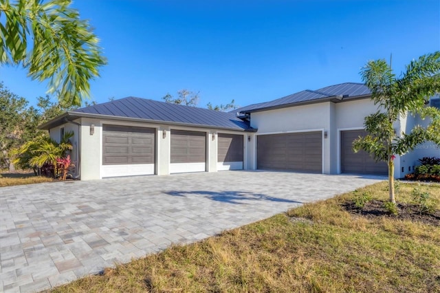 garage featuring decorative driveway