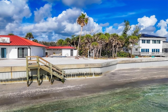 back of house featuring a water view