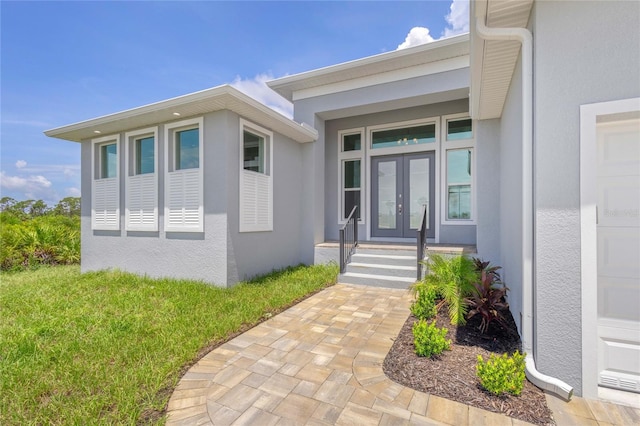 property entrance with a lawn and french doors