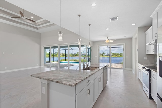 kitchen with sink, range with electric cooktop, a kitchen island with sink, and white cabinets