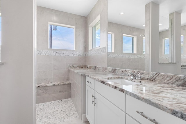 bathroom featuring vanity and tiled shower