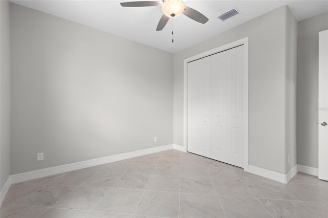 unfurnished bedroom with a closet and ceiling fan