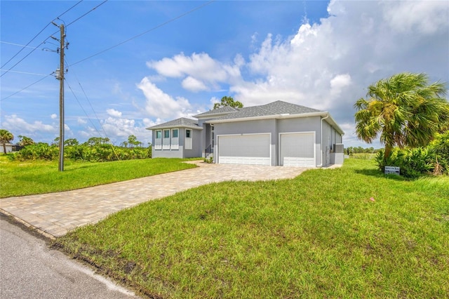 view of front of house with a garage and a front yard