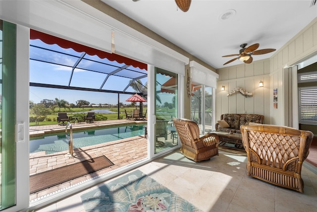 sunroom / solarium featuring a healthy amount of sunlight and ceiling fan