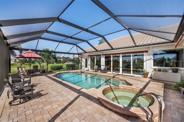 view of pool with an in ground hot tub, a patio area, and a lanai