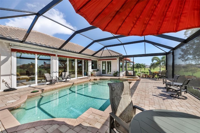 view of pool with a patio and a lanai