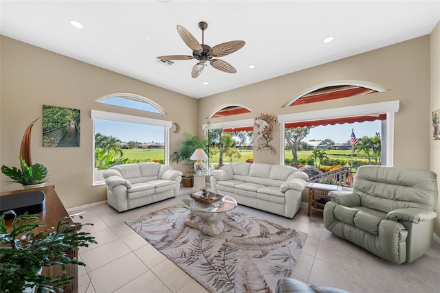 living area featuring visible vents, baseboards, ceiling fan, tile patterned floors, and recessed lighting