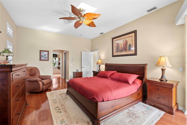 bedroom with multiple windows, light hardwood / wood-style flooring, and ceiling fan