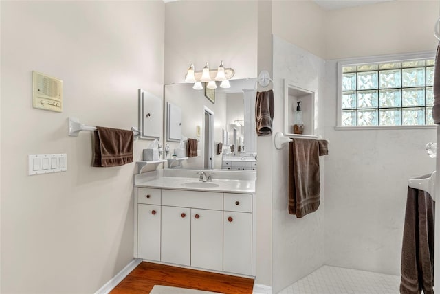 bathroom with hardwood / wood-style flooring and vanity