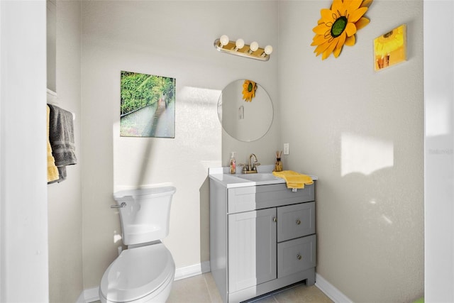 bathroom featuring toilet, tile patterned floors, and vanity