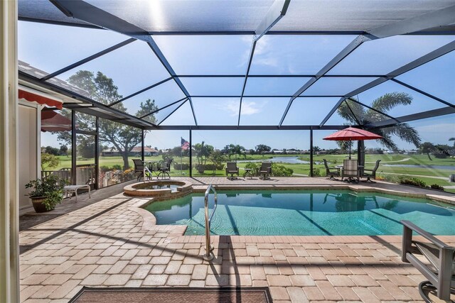 view of pool featuring an in ground hot tub, glass enclosure, and a patio