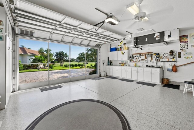 garage with ceiling fan and a garage door opener