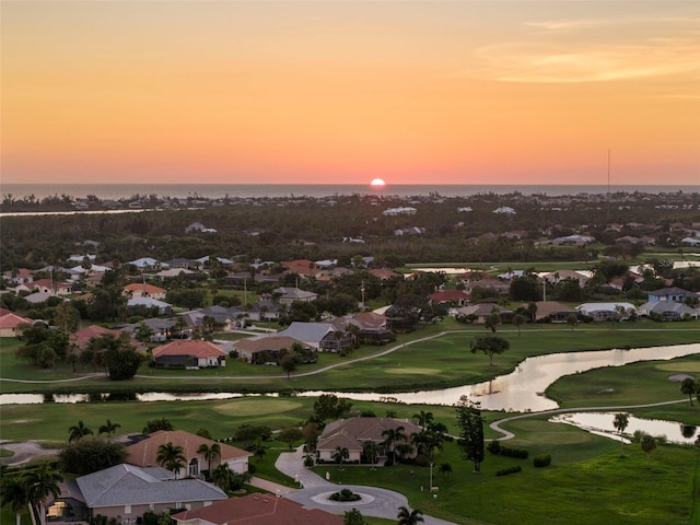 aerial view featuring a residential view, view of golf course, and a water view