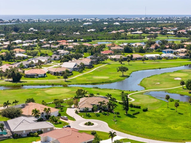 aerial view with view of golf course, a water view, and a residential view