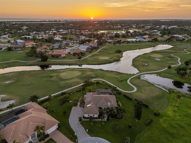 bird's eye view featuring golf course view, a water view, and a residential view