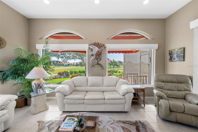 tiled living room featuring baseboards and recessed lighting