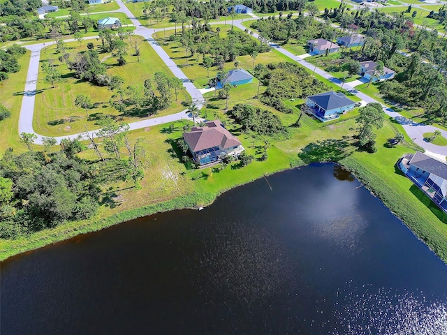 birds eye view of property with a water view and a residential view