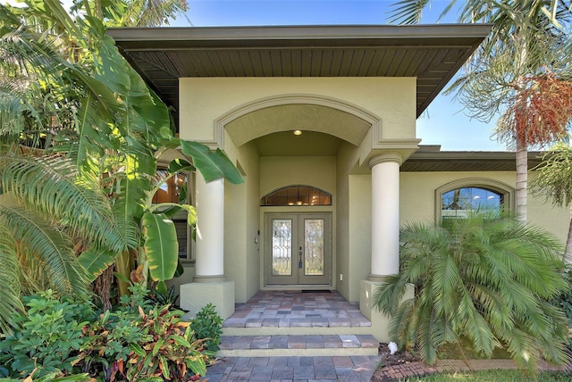 property entrance featuring french doors and stucco siding