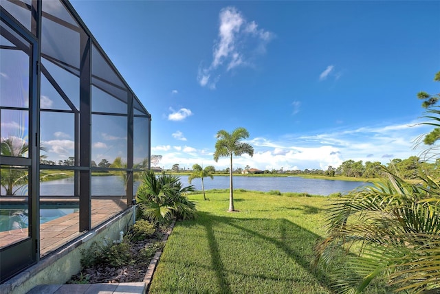 view of yard featuring a lanai, a water view, and an outdoor pool