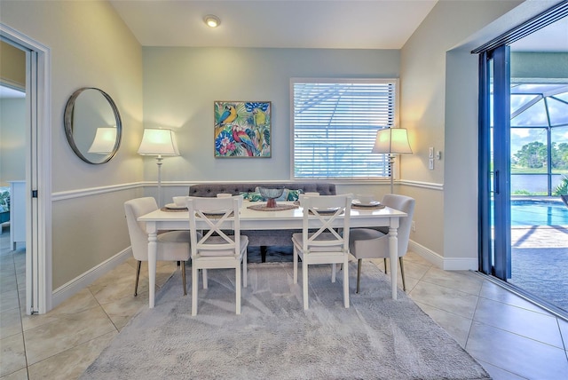 dining room featuring light tile patterned flooring and baseboards