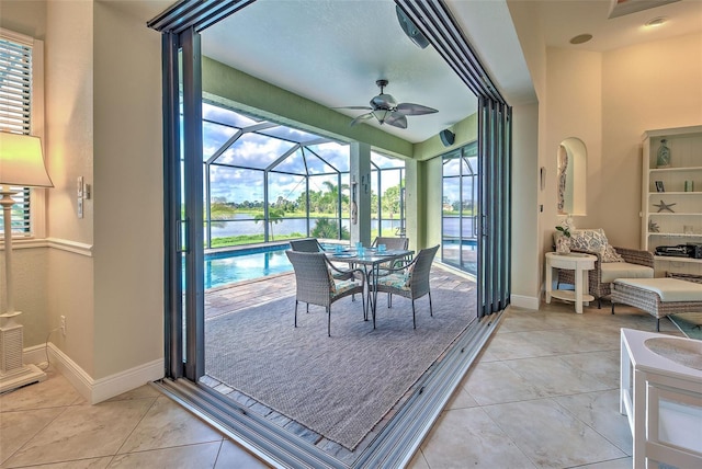 sunroom featuring ceiling fan