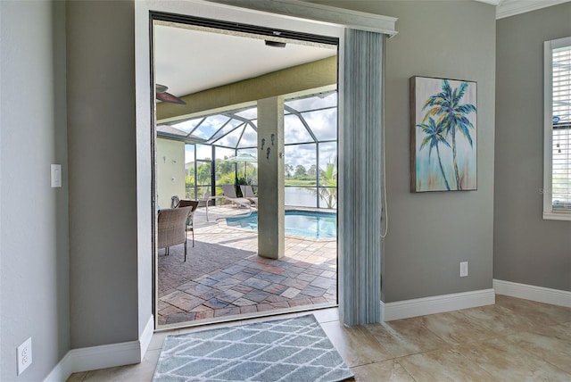 entryway featuring light tile patterned floors, a sunroom, and baseboards