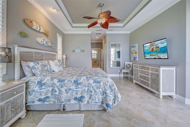 bedroom featuring baseboards, a tray ceiling, ceiling fan, and crown molding