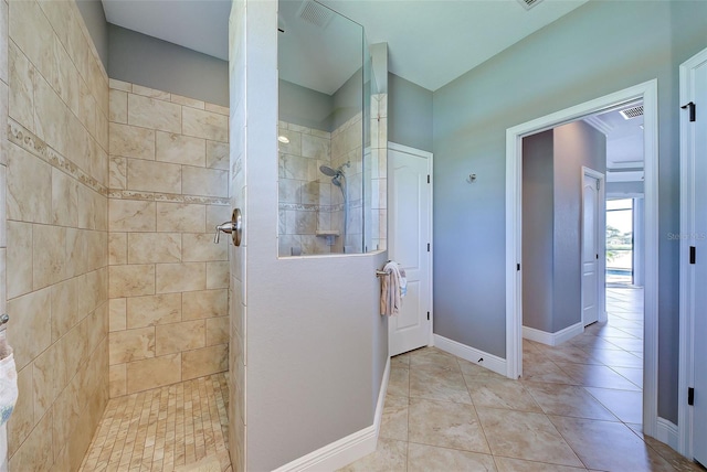 bathroom featuring a walk in shower, baseboards, and tile patterned floors