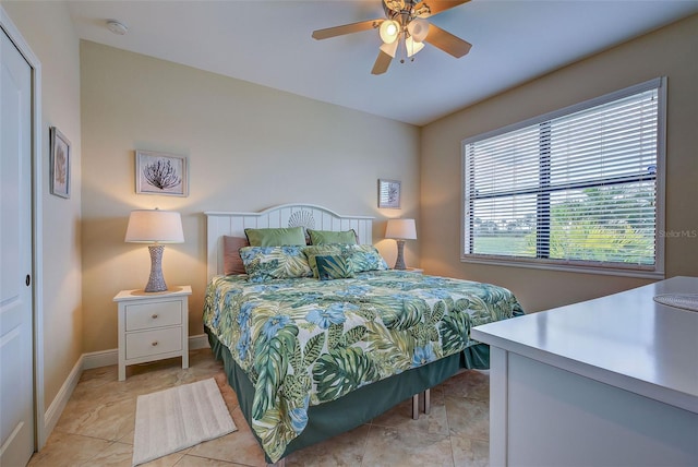 bedroom featuring ceiling fan and baseboards