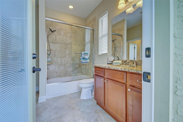 bathroom featuring toilet, bath / shower combo with glass door, vanity, and tile patterned floors