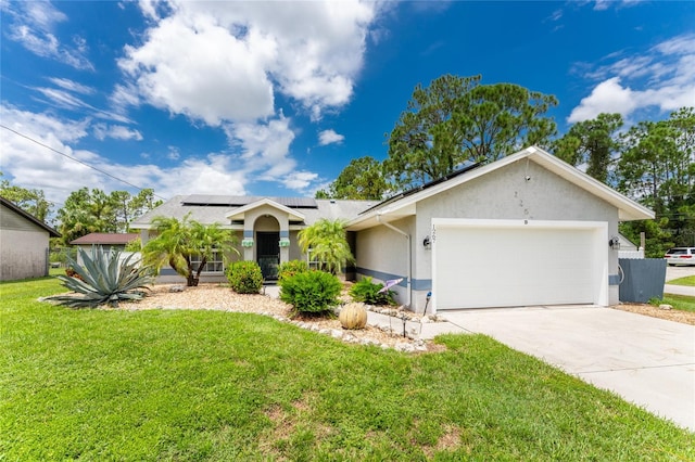 ranch-style house featuring a garage, solar panels, and a front yard