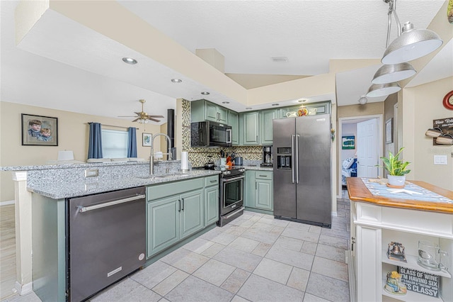 kitchen featuring appliances with stainless steel finishes, light stone counters, tasteful backsplash, kitchen peninsula, and green cabinetry