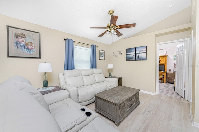 living room featuring ceiling fan, vaulted ceiling, and hardwood / wood-style flooring