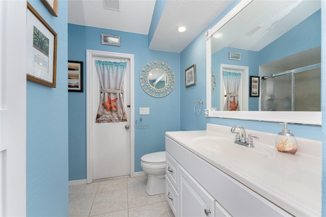 bathroom featuring tile patterned flooring, toilet, and vanity