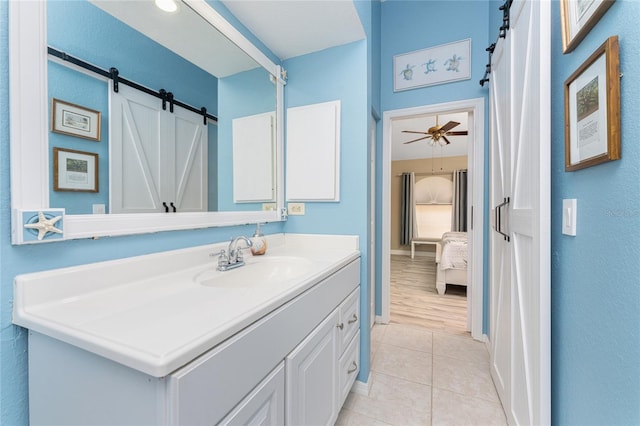 bathroom with ceiling fan, hardwood / wood-style floors, and vanity