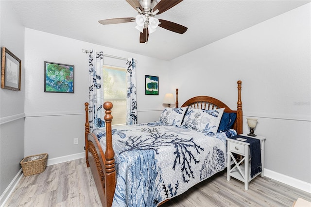 bedroom with light hardwood / wood-style floors and ceiling fan