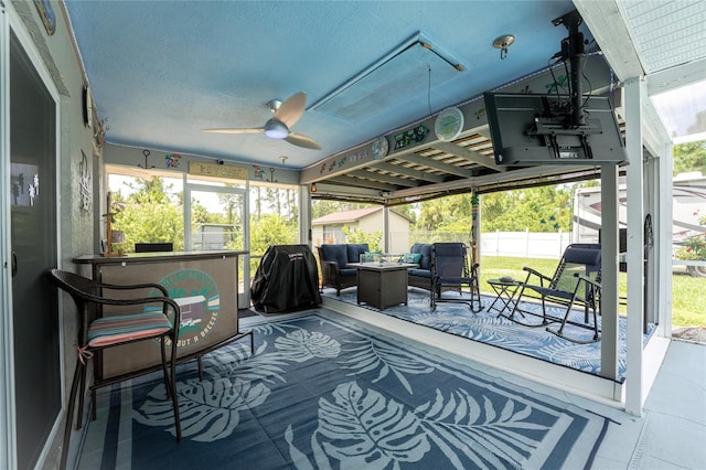 sunroom with ceiling fan and a healthy amount of sunlight