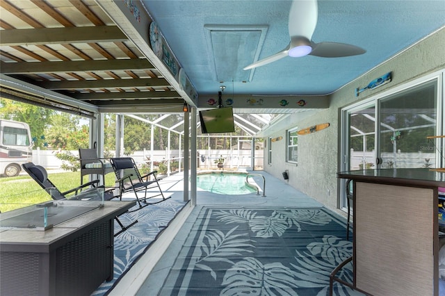 sunroom / solarium with ceiling fan and a healthy amount of sunlight