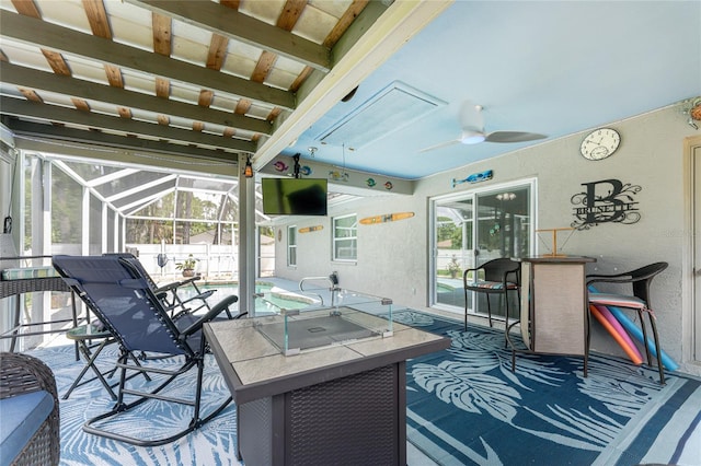 view of patio / terrace featuring ceiling fan and glass enclosure