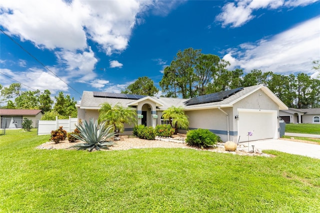 ranch-style home featuring solar panels, a garage, and a front yard