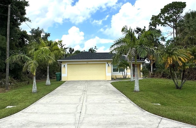 view of front of home with stucco siding, an attached garage, driveway, and a front yard