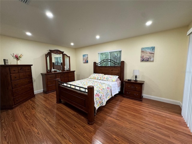 bedroom featuring dark wood-style floors, recessed lighting, and baseboards