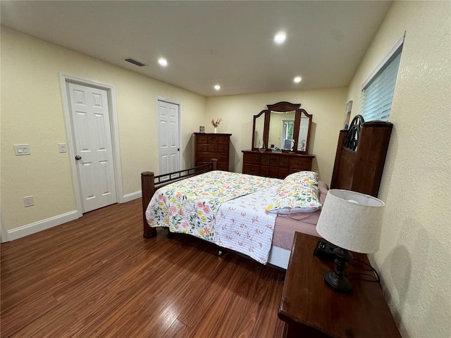 bedroom featuring visible vents, recessed lighting, wood finished floors, and baseboards